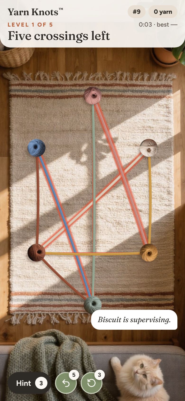A level in progress on the rug: crossing strings glow red while Biscuit watches from the sofa